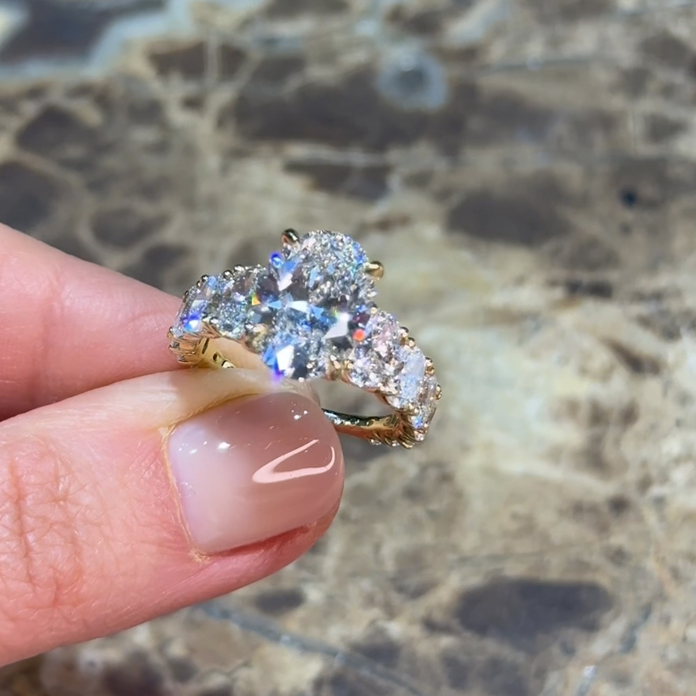 18k yellow gold oval lab-grown diamond engagement ring with ¾ set graduating oval diamonds