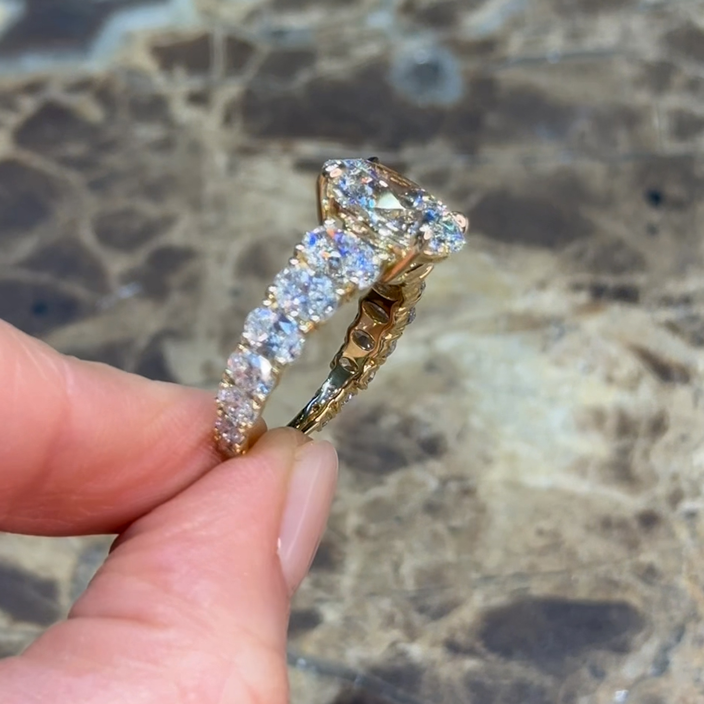 18k yellow gold oval lab-grown diamond engagement ring with ¾ set graduating oval diamonds
