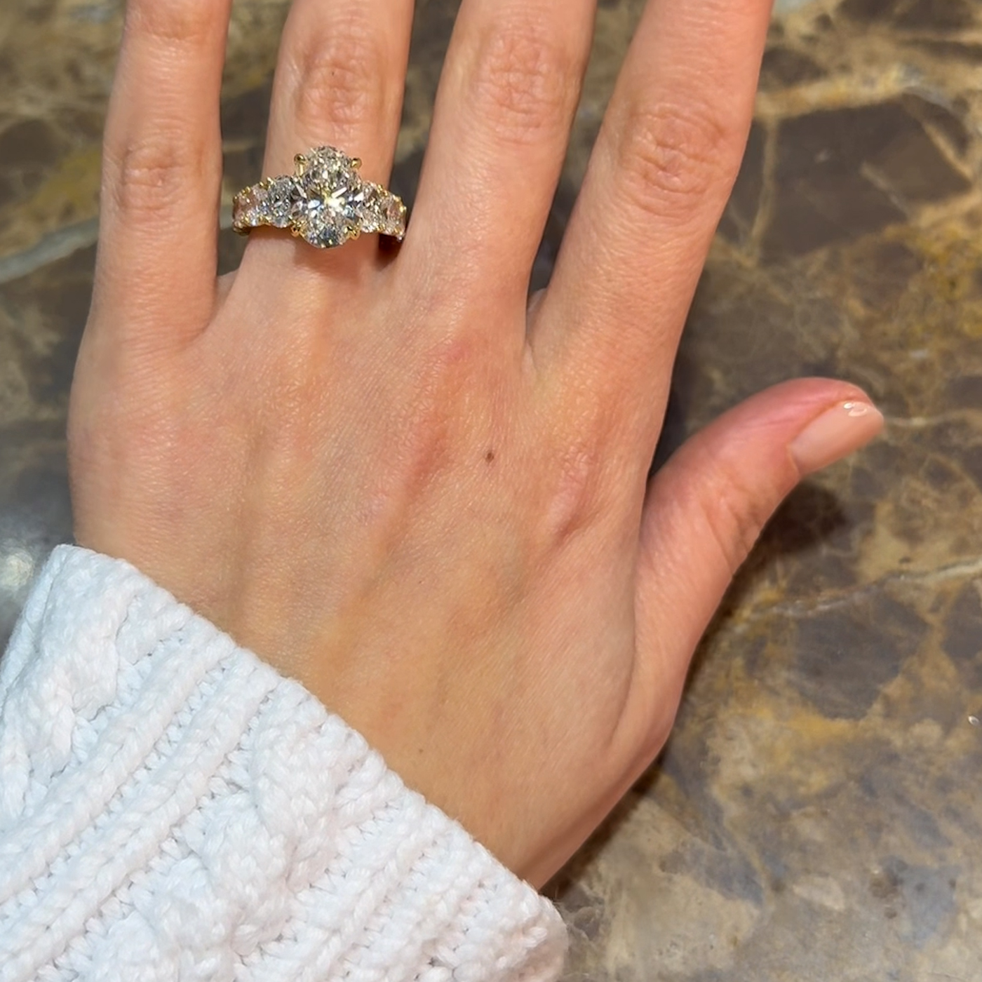 18k yellow gold oval lab-grown diamond engagement ring with ¾ set graduating oval diamonds