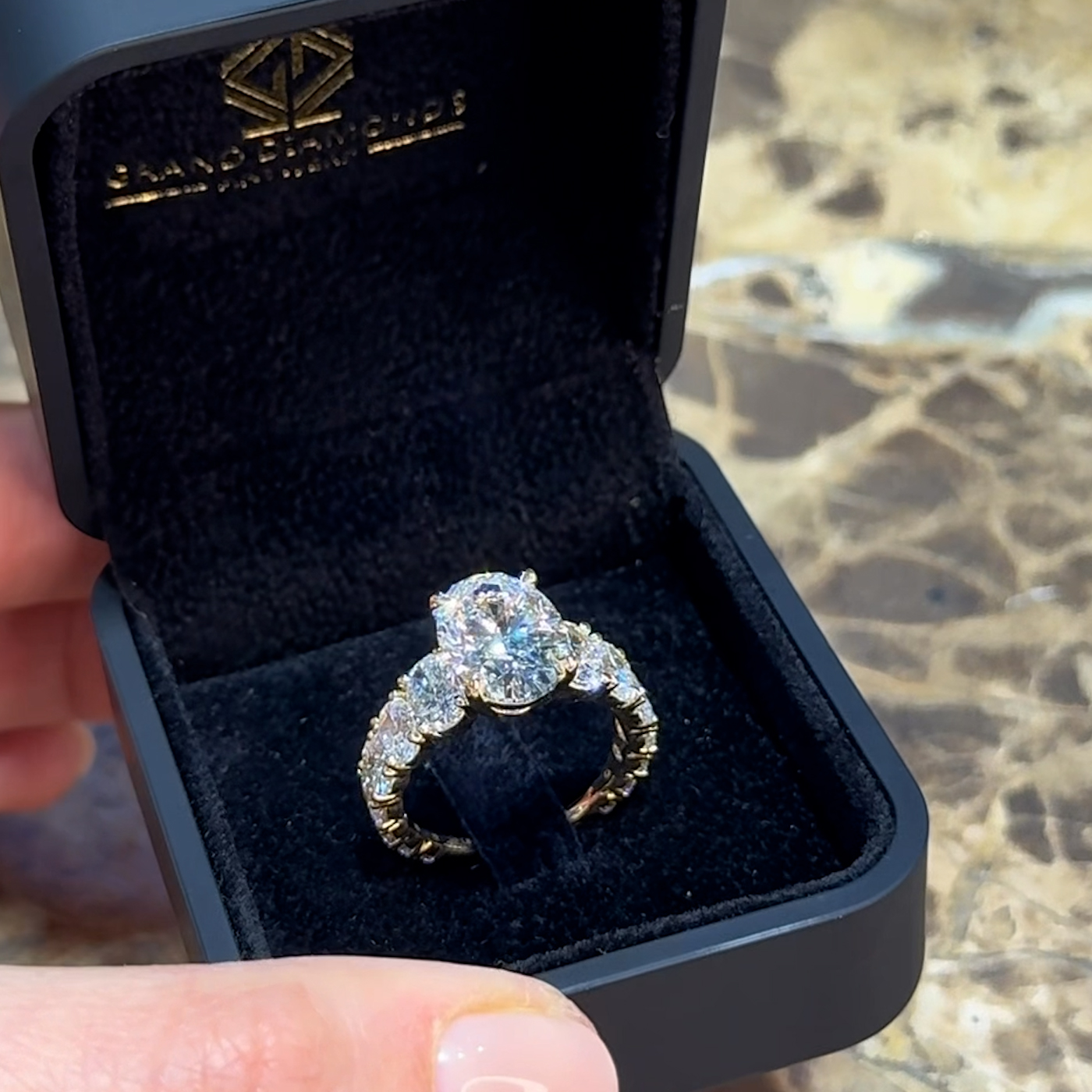 18k yellow gold oval lab-grown diamond engagement ring with ¾ set graduating oval diamonds