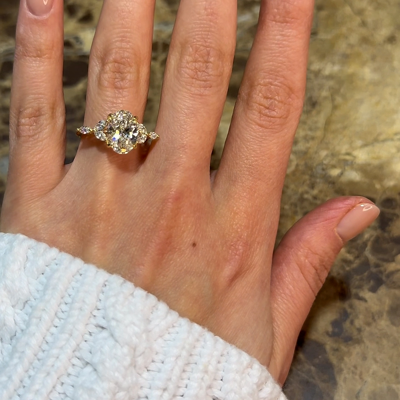 18k yellow gold oval lab-grown diamond engagement ring with marquise side stones and floral gallery