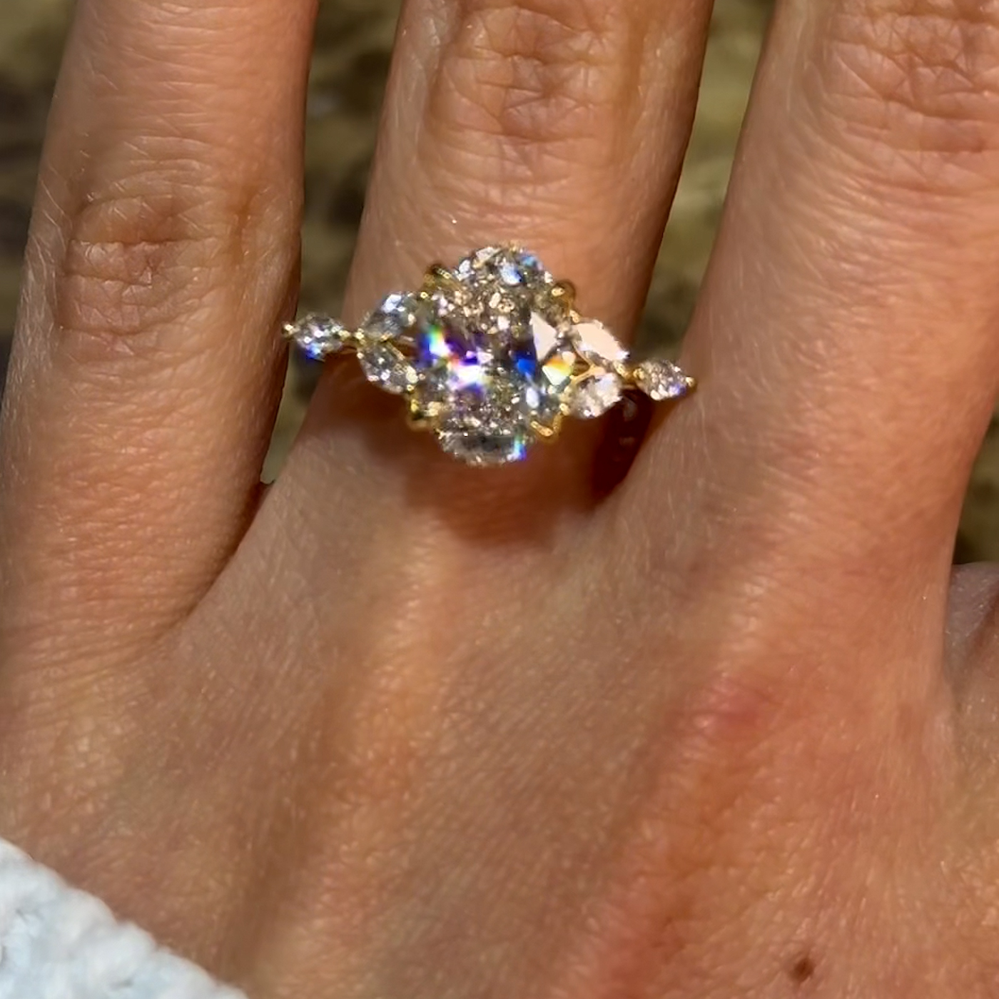 18k yellow gold oval lab-grown diamond engagement ring with marquise side stones and floral gallery