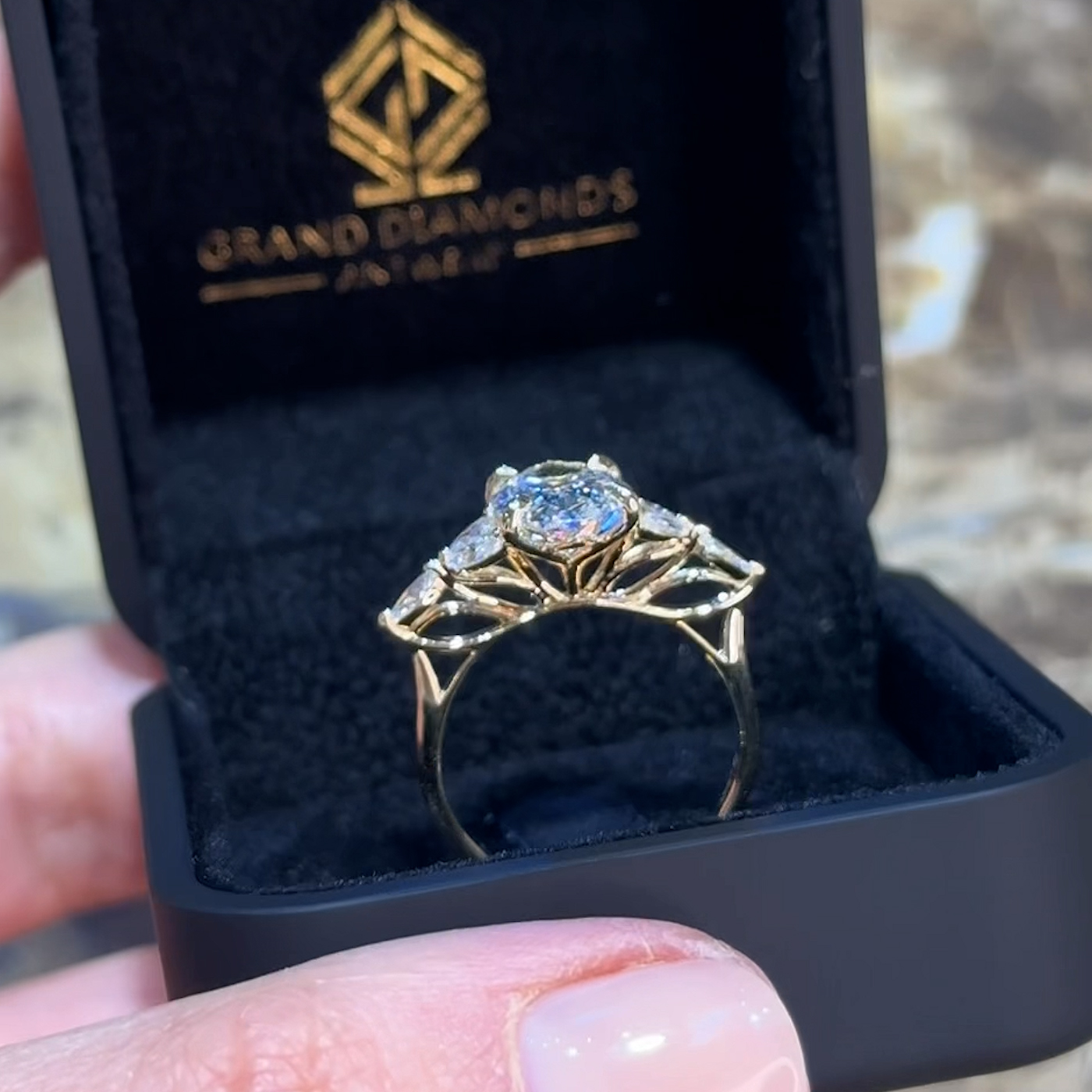 18k yellow gold oval lab-grown diamond engagement ring with marquise side stones and floral gallery