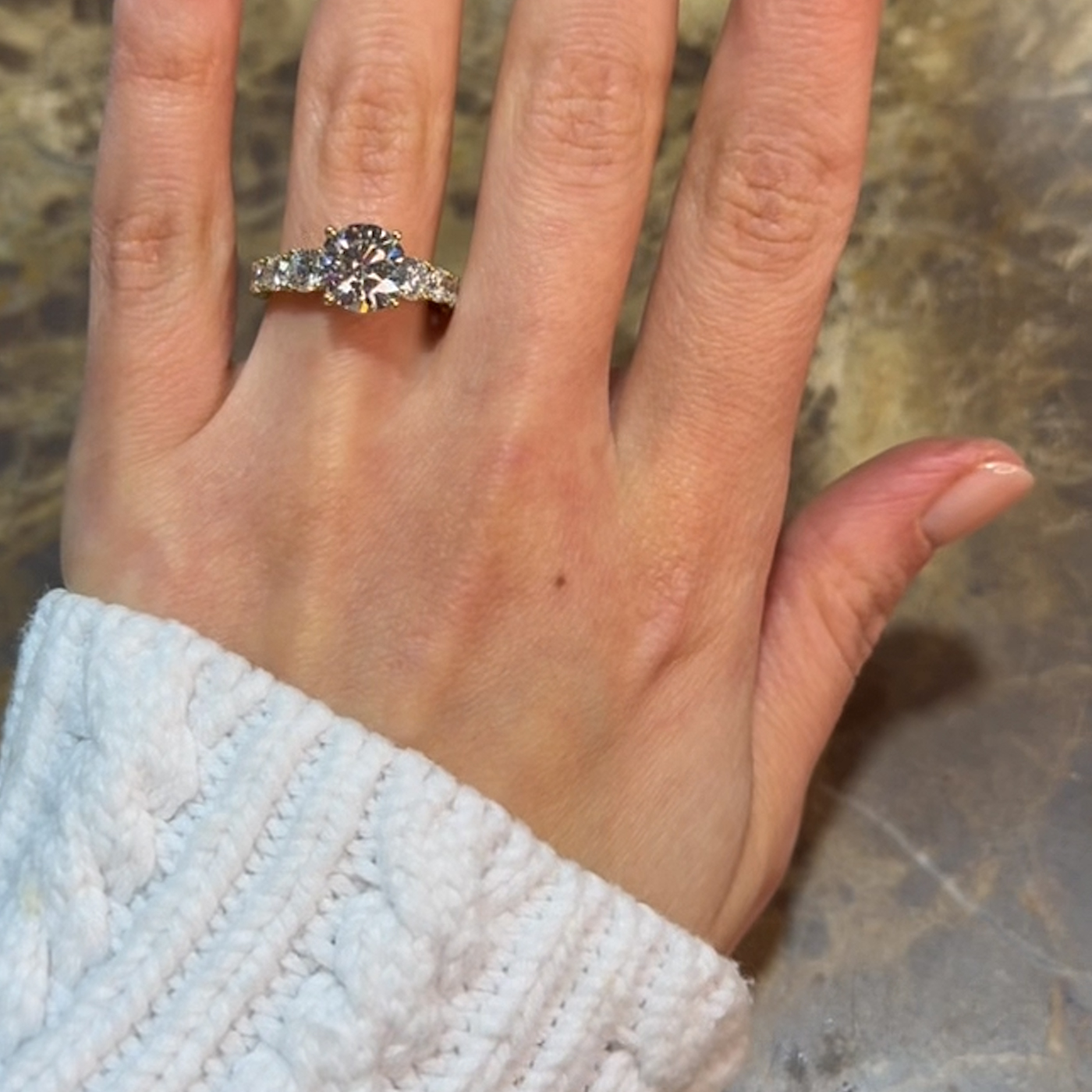 18k yellow gold round lab-grown diamond engagement ring with ¾ set graduating round diamonds