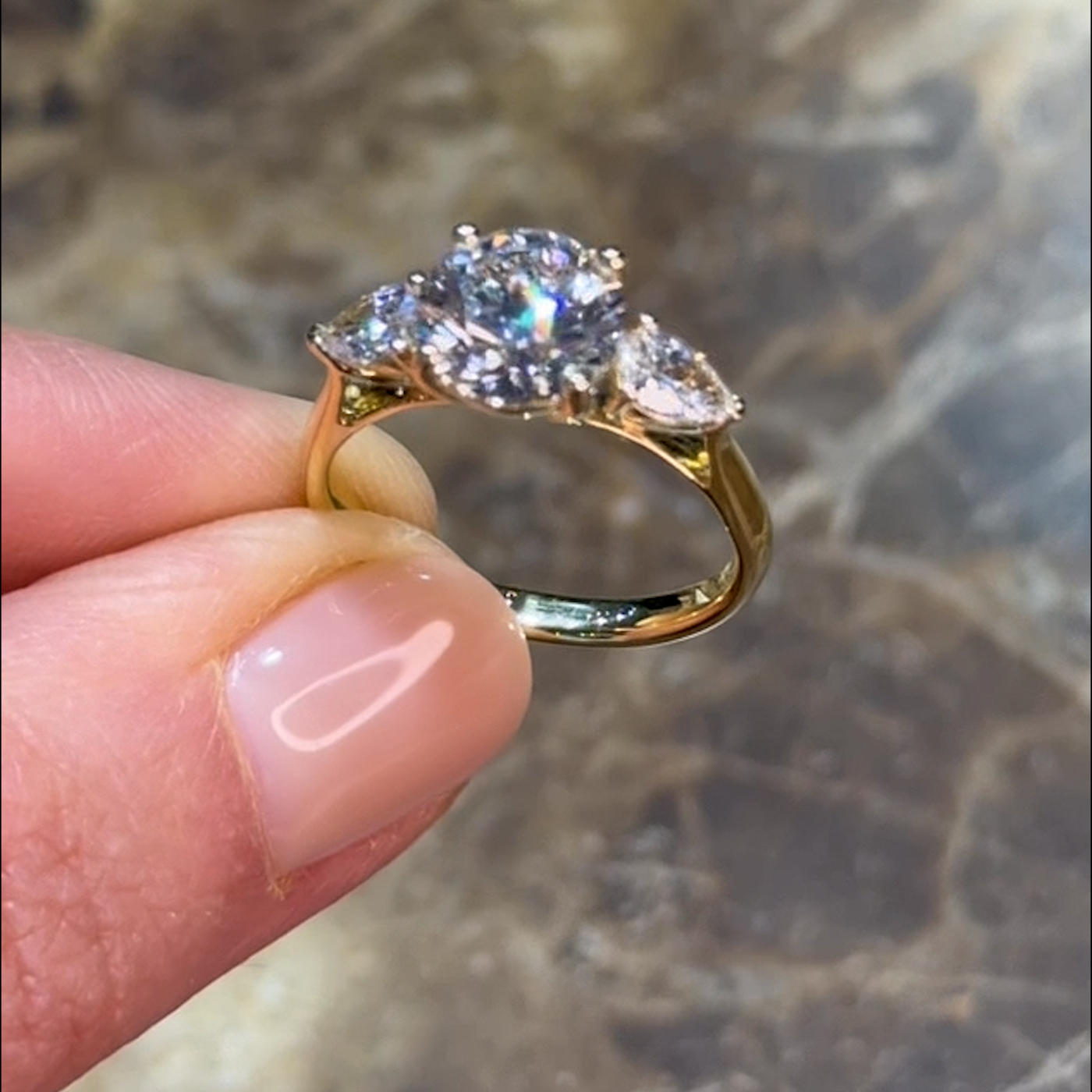 18k yellow gold  18k yellow gold round cut lab-grown trilogy ring with pear shaped side diamonds
